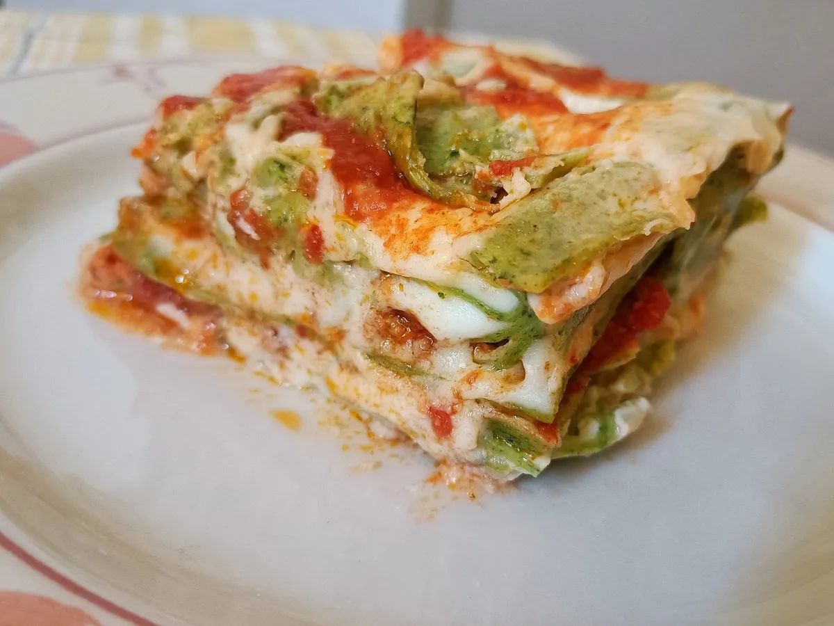 A portion of baked lasagne with the layers of pasta and filling in view